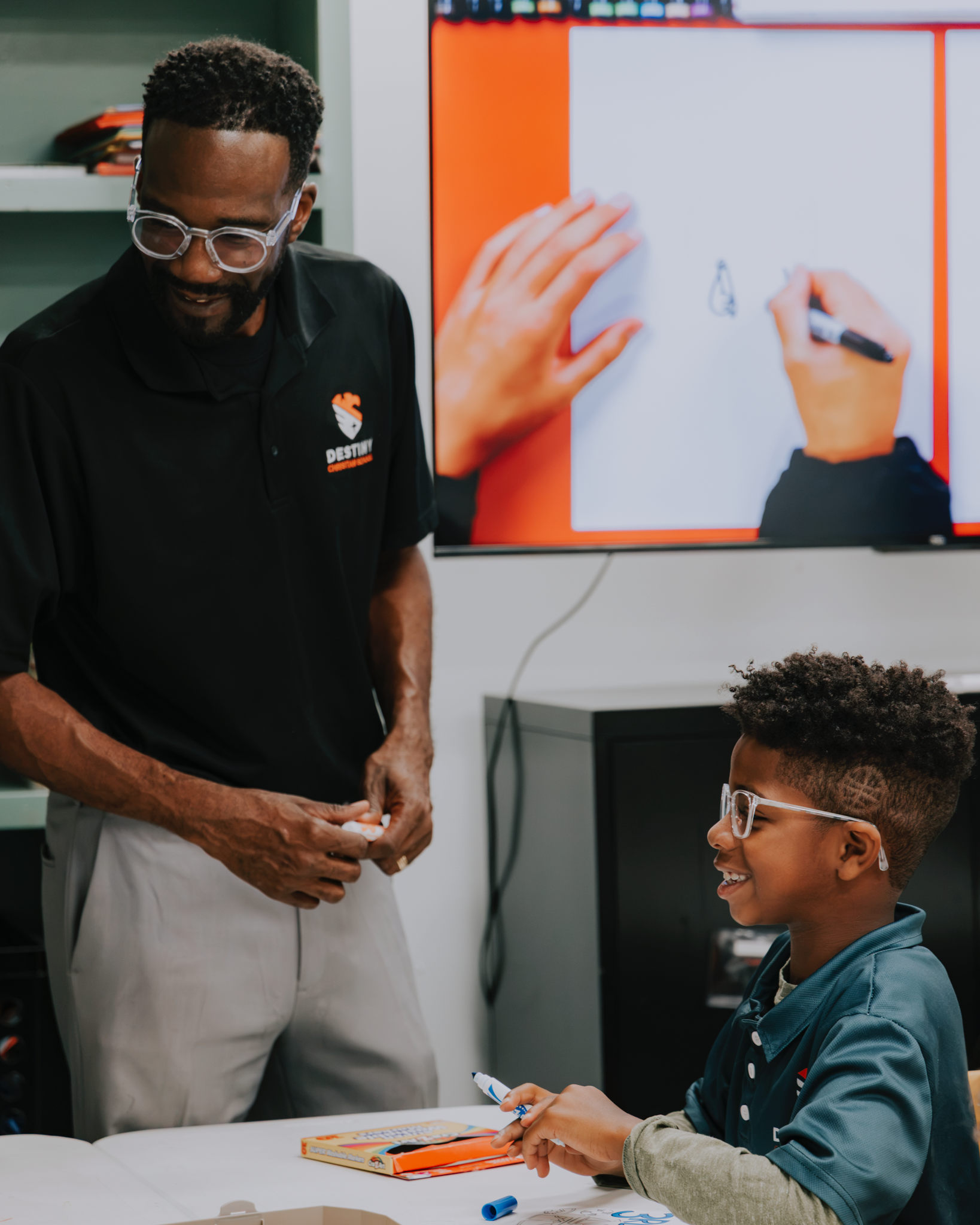 A Destiny teacher giving a student personal encouragement during a lesson