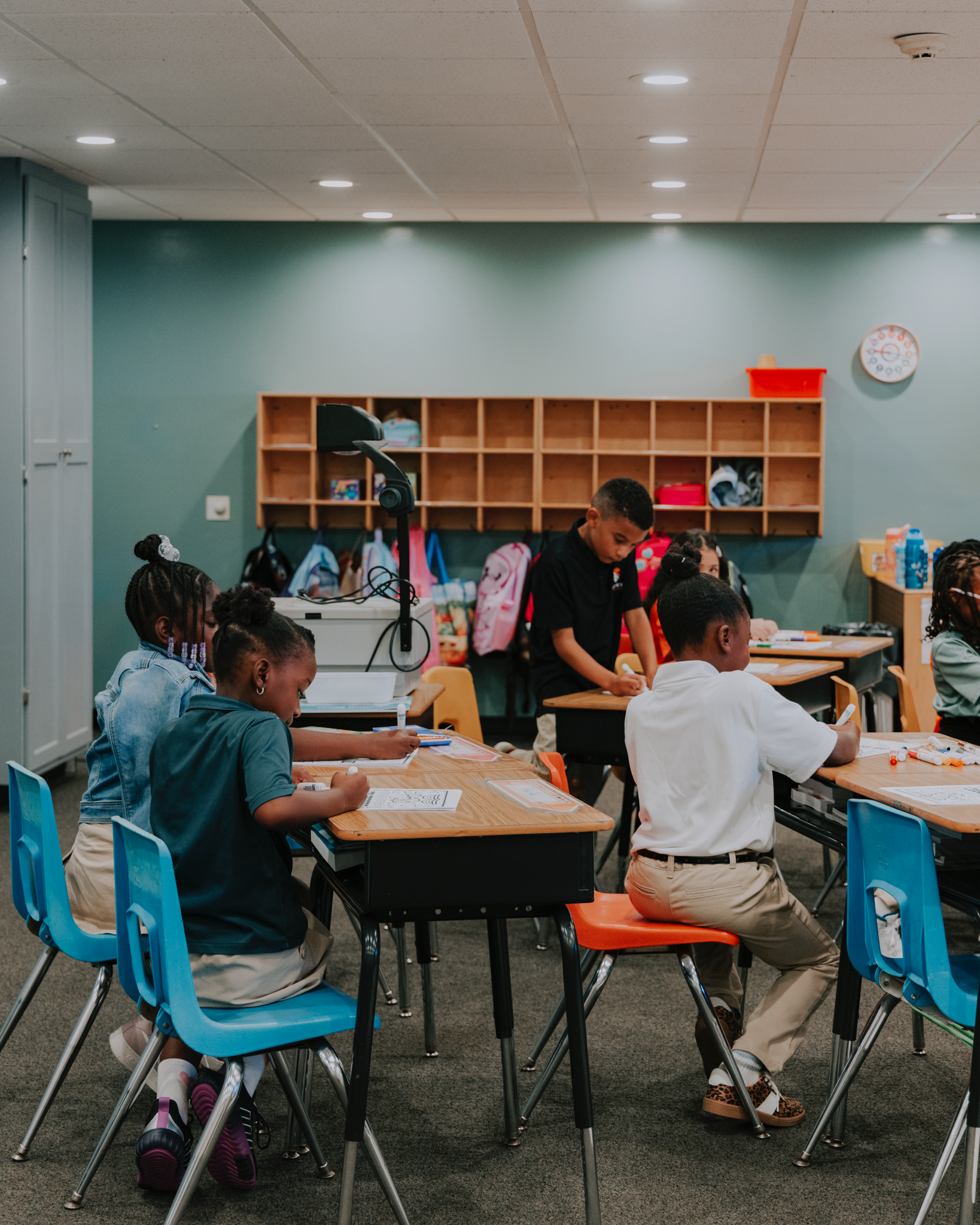 Destiny students learning together around classroom tables